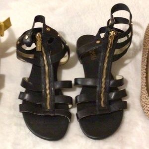 Michael Kors flat slide foot in hightop leather sandals with zipper detail.